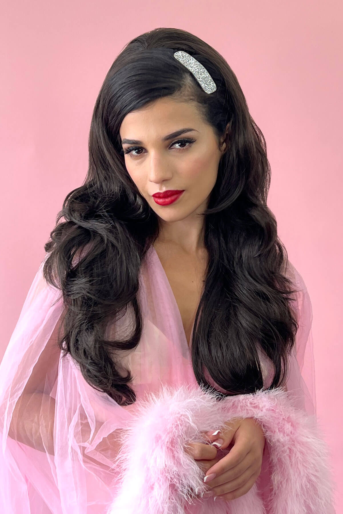 Woman with long wavy hair wearing a headband against a pink background. High crown long layered half wig and volume ring Helena 24BH613 