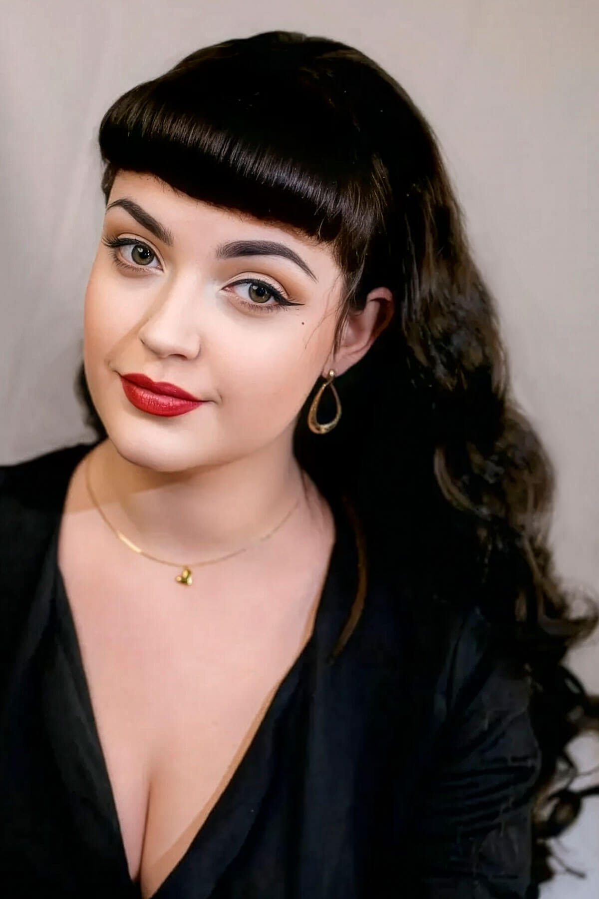 Woman with long, wavy brown hair and makeup wearing a black top against a neutral background. Ultra long half wig with hollywood waves. chestnut brown 8