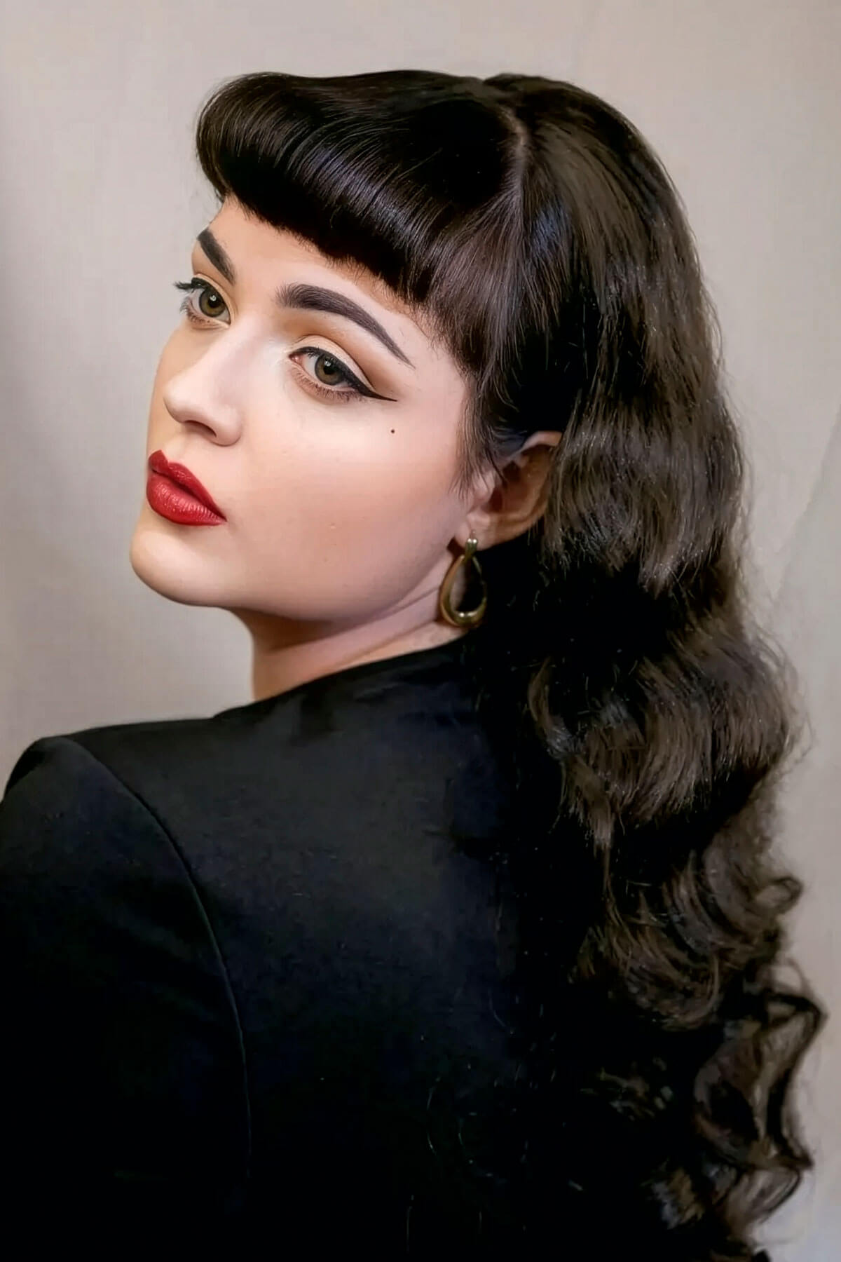 Woman with long, wavy brown hair and makeup wearing a black top against a neutral background. Ultra long half wig with hollywood waves. chestnut brown 8