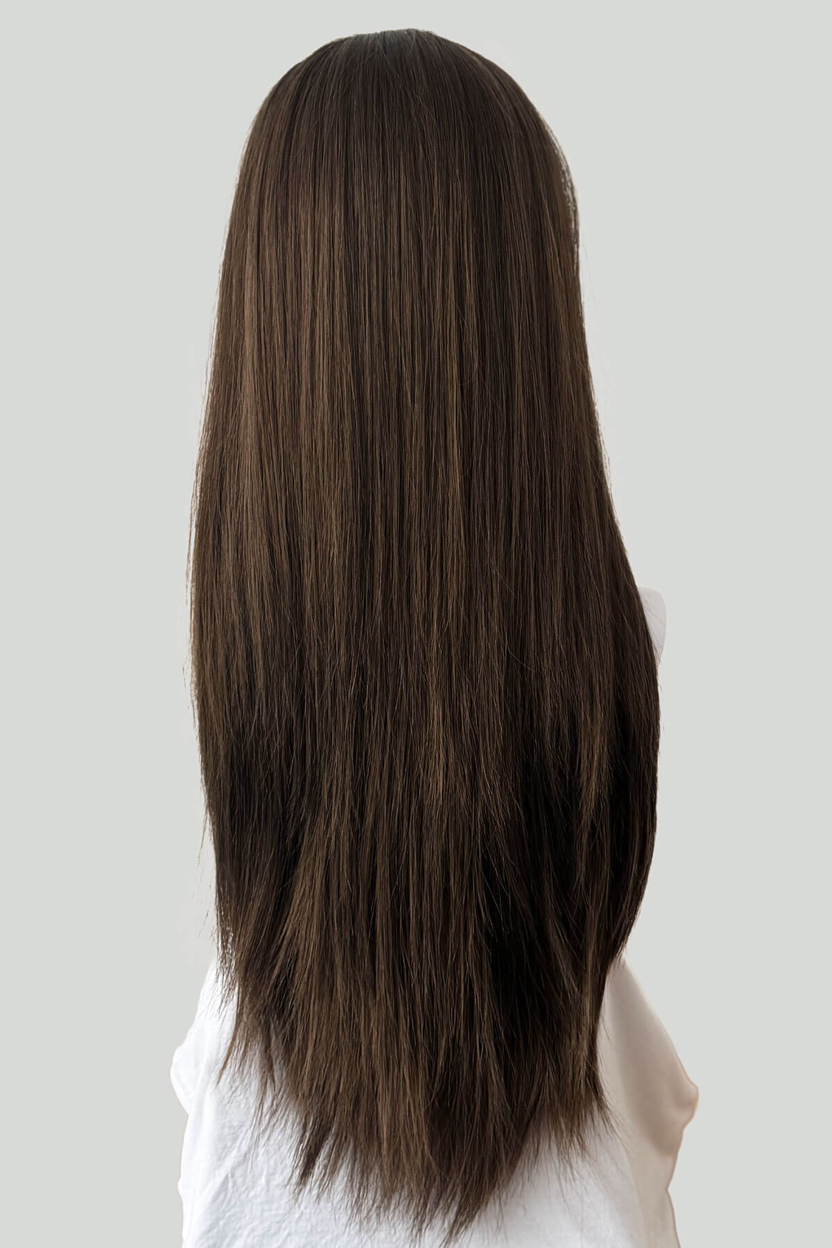 Long brown hair on a mannequin head against a plain background. Straight brown half wig hairpiece extension, long: Faye Mocha brown 10