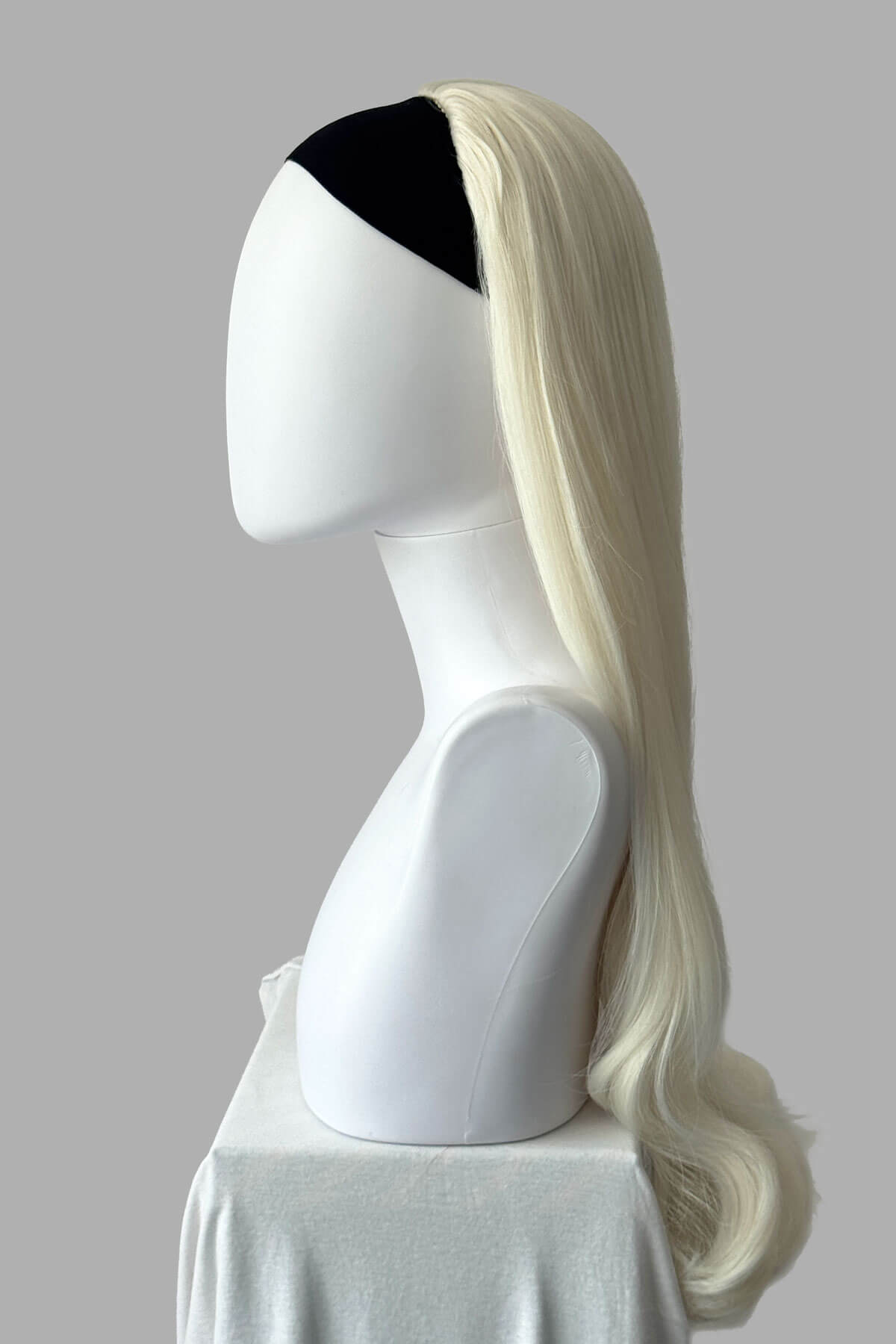 Long, platinum blonde half wig on a plain background. Kate - Heat Styleable Extra Long, Gentle Wave Half Wig  dark platinum blonde 1001