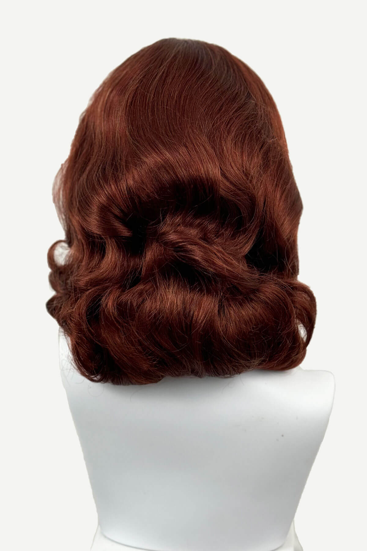 Brown wig on a white mannequin head against a white background, viewed  from the back. 1950s style shoulder length half wig hairpiece with beautiful vintage waves: Onyx copper red 130