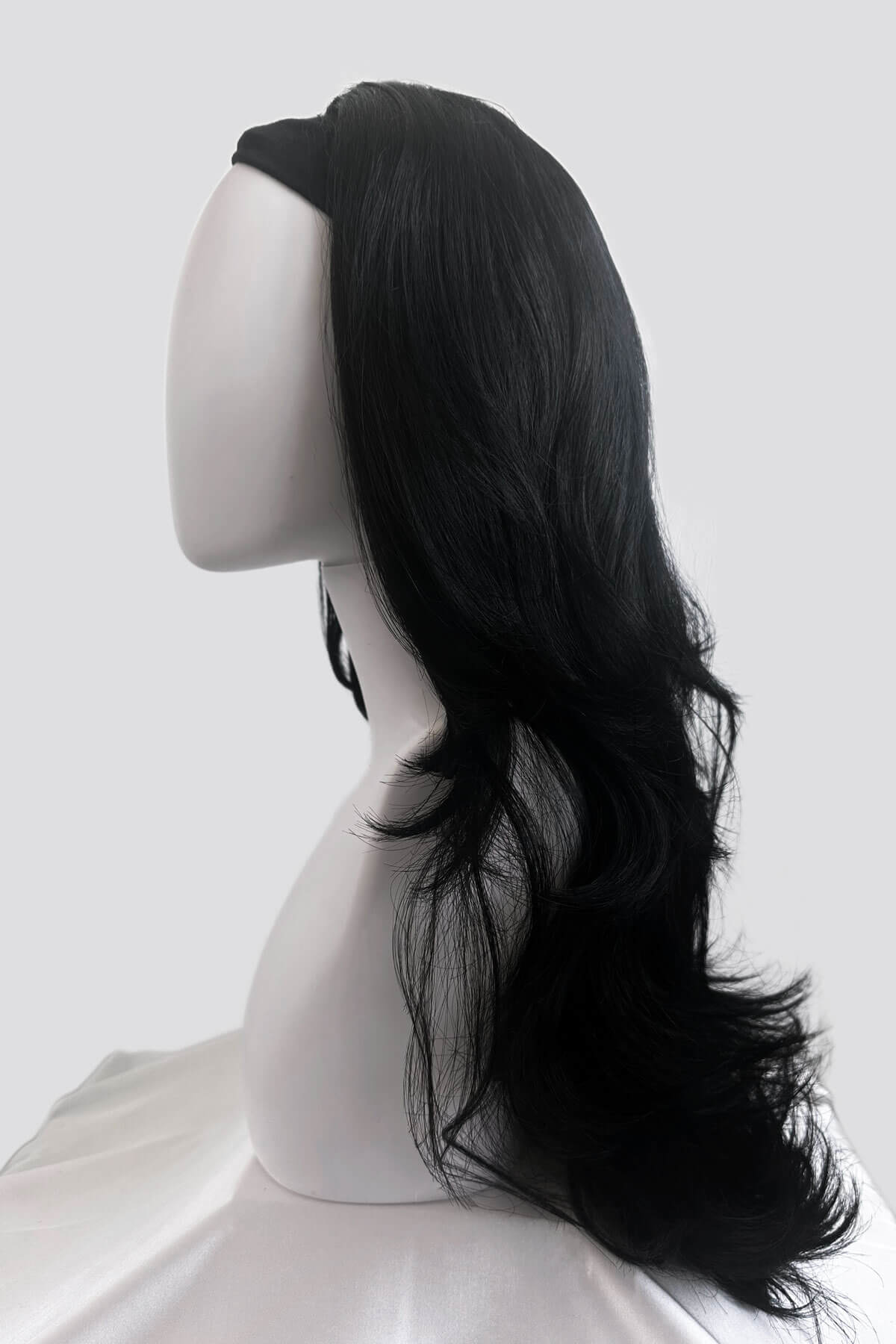 Black wig on a mannequin head against a white background. Black half wig hairpiece (3/4 wig), long layers: Aislynn jet black #1