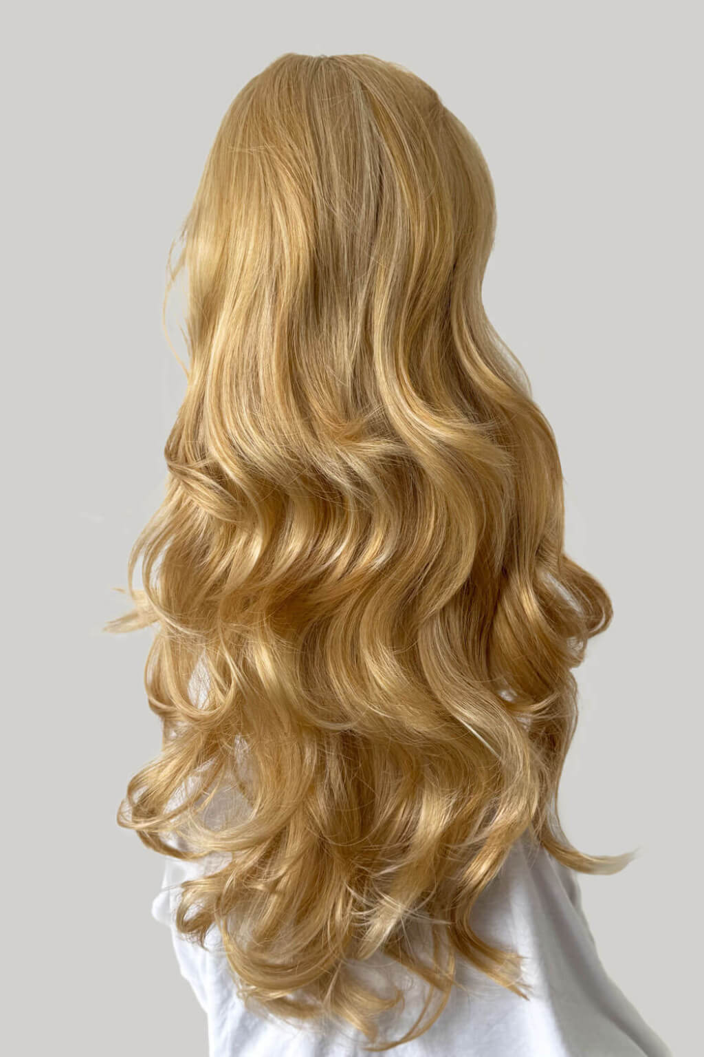 Blonde wig on a mannequin head against a plain background. Suki - Super Full Volume, Extra Long, Bouncy Brown Half Wig blonde 24BH613