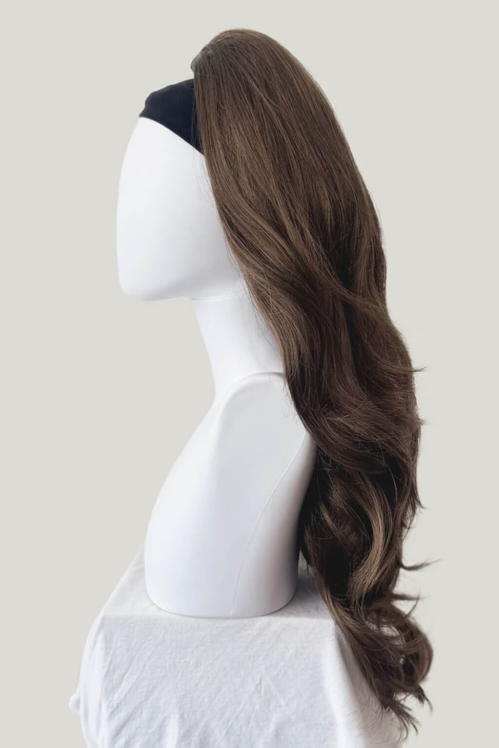 Brown hair extension on a mannequin head against a white background. High crown long, wavy half wig and volume ring: Bardot mocha brown 10