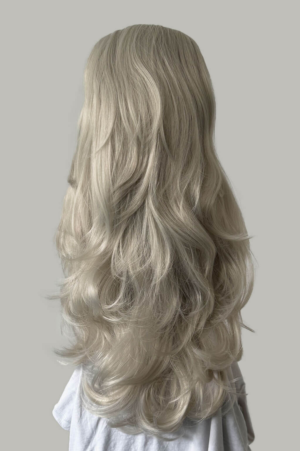 Blonde wig with wavy hair on a plain background -  High crown long, layered half wig and volume ring: Helena silver