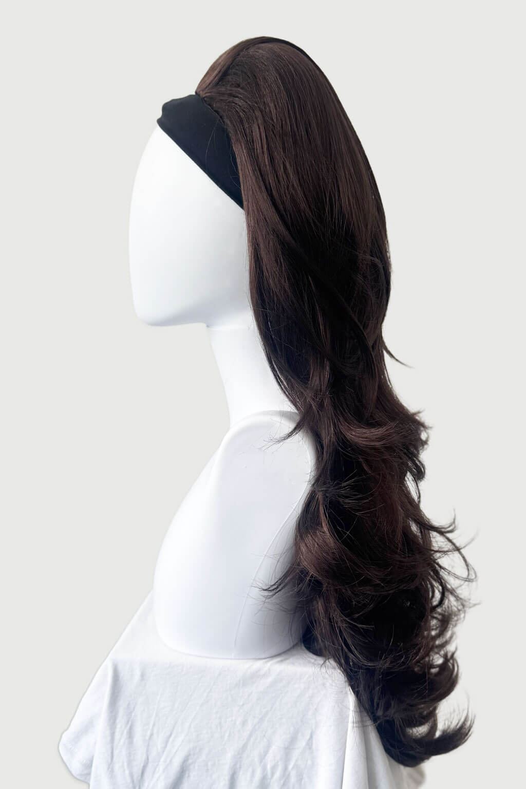 Mannequin head with long dark brown hair styled in a ponytail on a white background - High crown long, layered half wig and volume ring: Helena reddish brown 6-33 