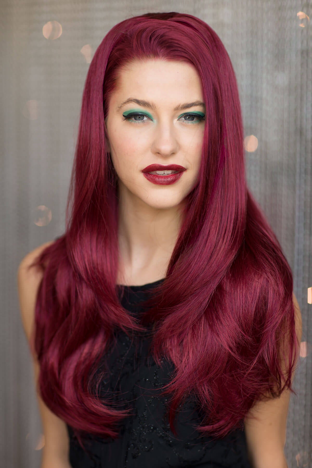 Woman with vibrant red hair and dark makeup against a neutral background. Straight red half wig hairpiece extension (half wig): Franchesca