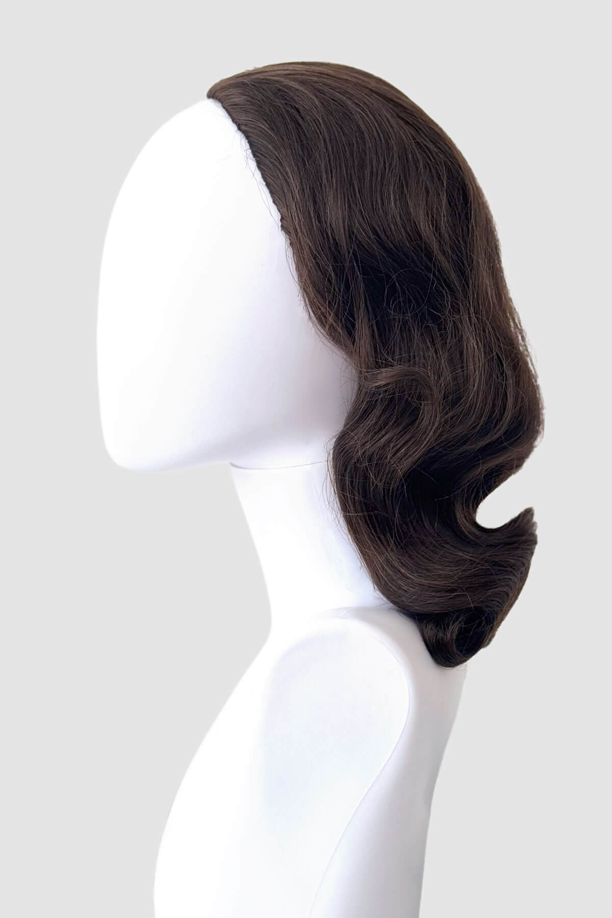 Brown wig on a mannequin head against a white background. 1940s style half wig hairpiece with beautiful marcel waves: Virginia chestnut brown 8