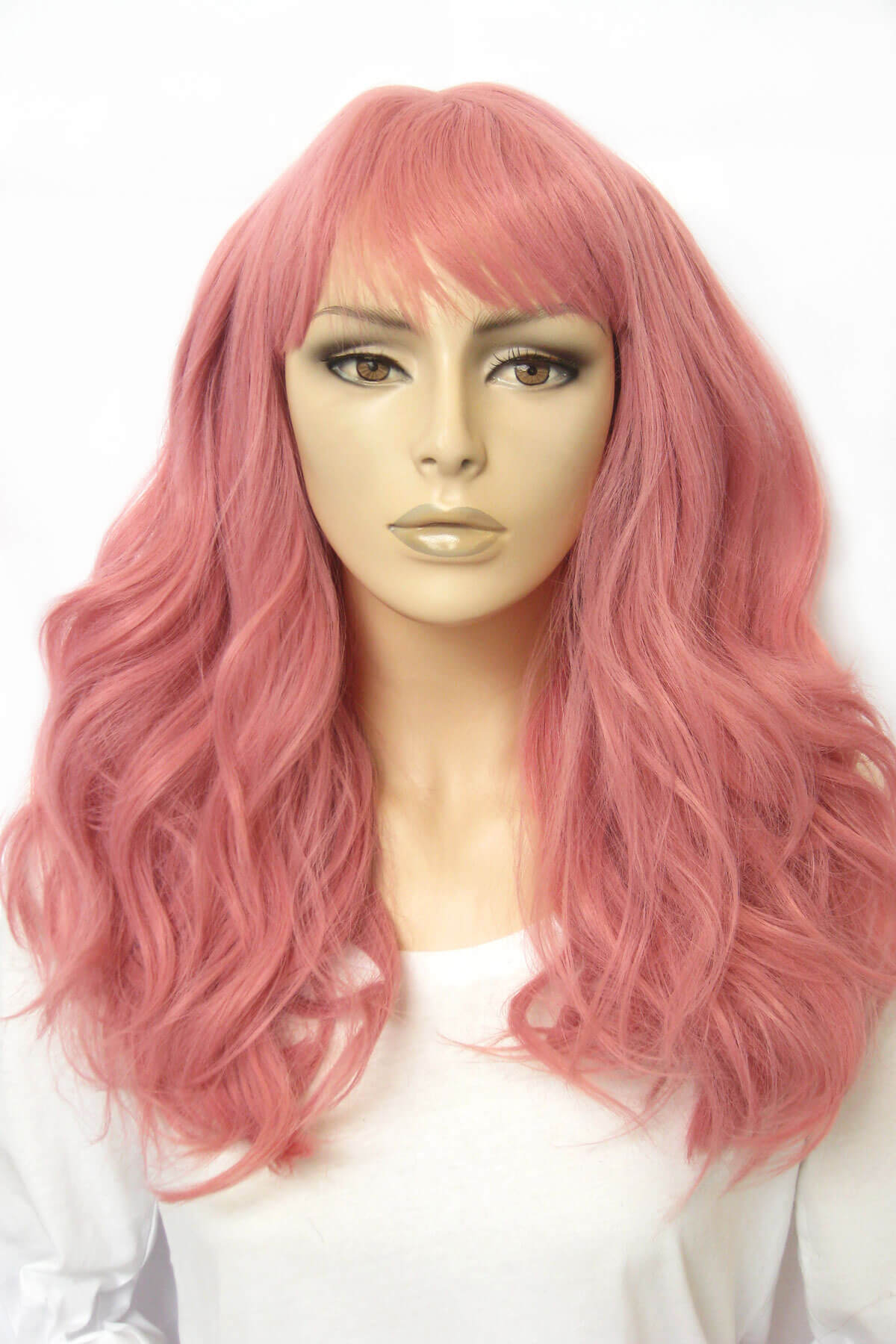 Mannequin head with pink wig on a white background. Dusty pastel pink wig with long cascading waves: Rosalie