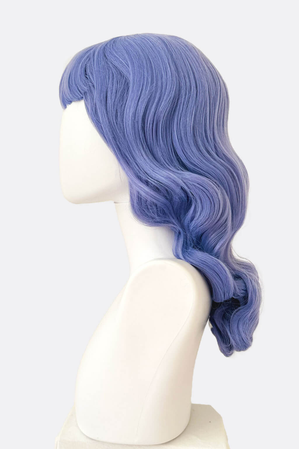 Blue wig on a mannequin head against a white background. Long blue-purple wig with short fringe and old Hollywood waves: Ophelia
