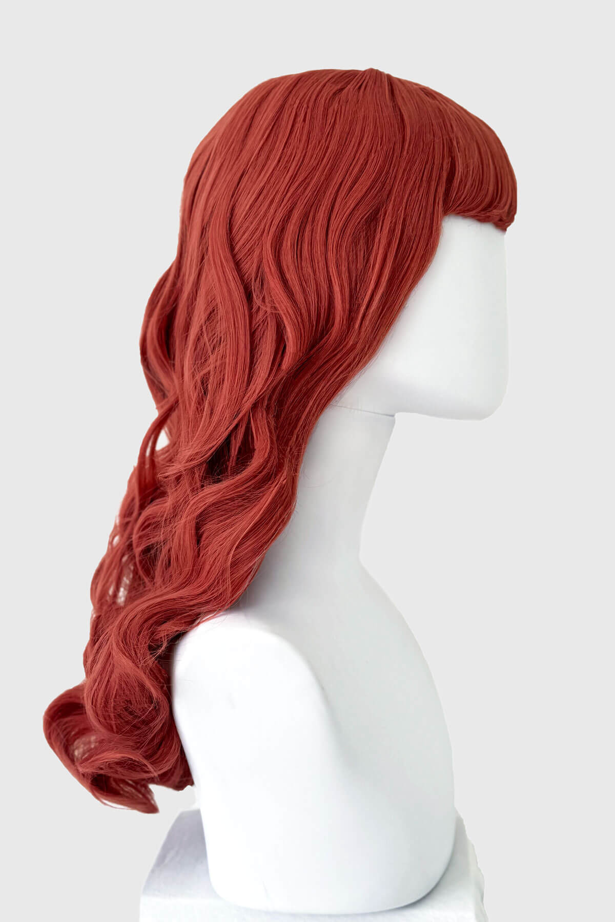 pastel-pink wig on a white mannequin head against a white background. Long pastel-pink pinup style wig with gentle waves and short fringe: Candy