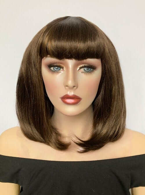 Mannequin head with brown wig and bangs on a plain background. Long bob wig with a short fringe, brown with blonde highlights: Jill