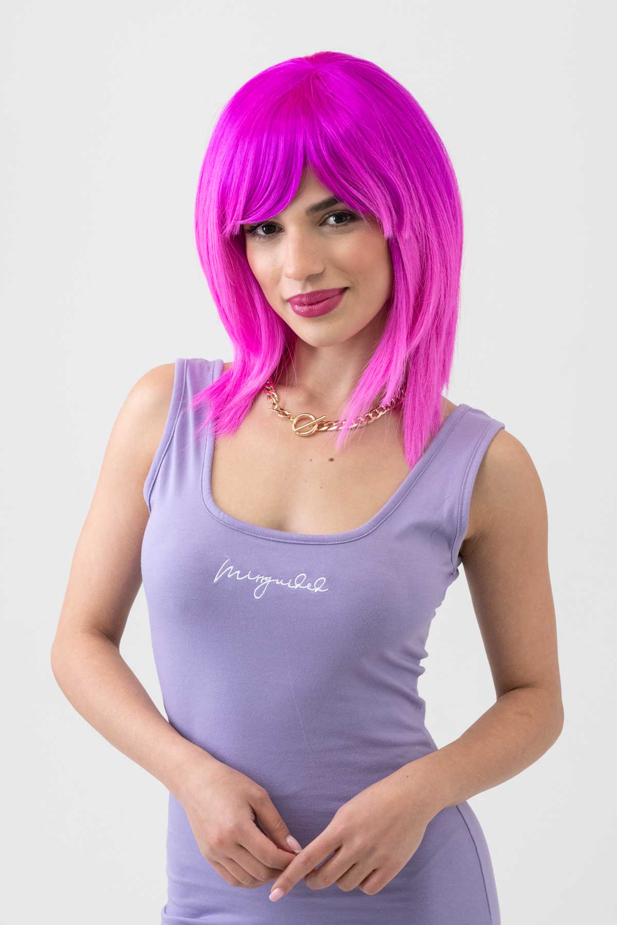 Woman with bright pink wig wearing a purple tank top with text on a white background. Pink dip dye wig (ombre), straight: Hetty