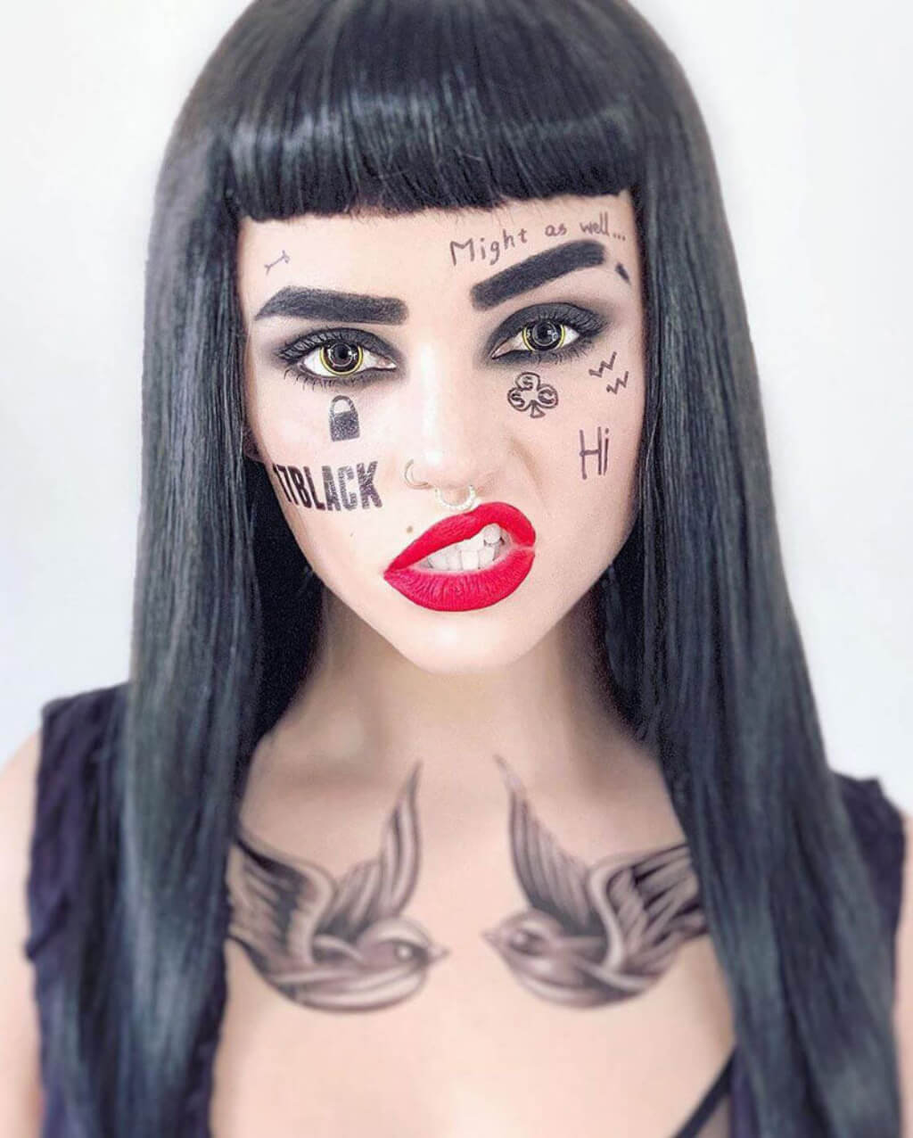 Person with black hair and art on face and neck against a white background. Long black wig with straight hair and a short, straight fringe: Maxine